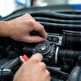 Technician servicing auto air conditioning