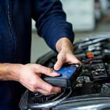 Technician performing engine diagnostics